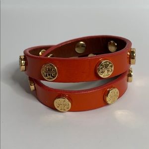Tory Burch wrap bracelet in orange and gold.